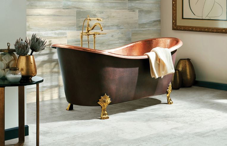 neutral grey tile flooring in a modern bathroom with a copper tub